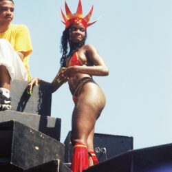 Carnival dancer in red costume on float