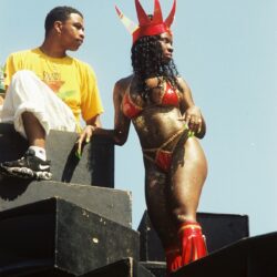 Woman in red carnival costume on float