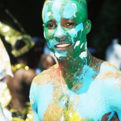 Smiling person covered in colorful body paint