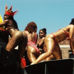 Dancers in glittery bikinis on speaker platform
