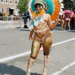 Carnival dancer wearing large feathered headdress