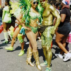 Couple in green and gold carnival costumes