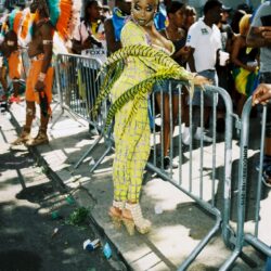 Person in yellow carnival costume by barricade