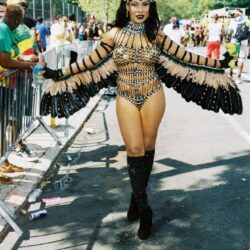 Person in beaded horned feathered carnival costume