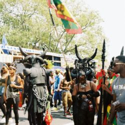 Carnival parade with participants in horned costumes