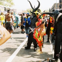 Carnival parade with horned costumes and dancers