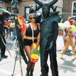 Horned demon and reveler at street carnival