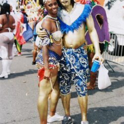Two revelers in blue and gold carnival costumes