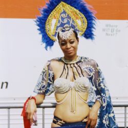 Woman wearing blue feathered carnival costume