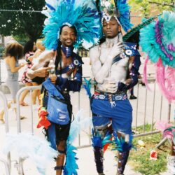 Two men in blue feathered carnival costumes
