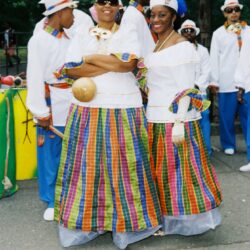Two women in colorful traditional Caribbean dress