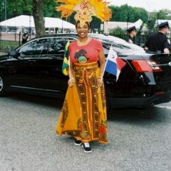 Smiling woman in orange feathered carnival costume