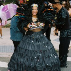 Smiling woman in black feathered carnival costume