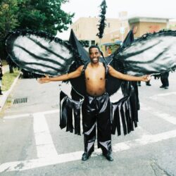 Man in large black butterfly wings costume