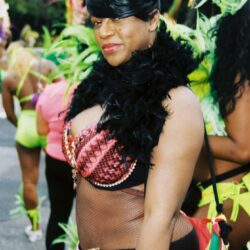 Woman in colorful carnival costume with feather boa