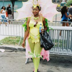 Woman in vibrant pink and green carnival costume