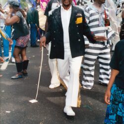 Dapper man with cane in vibrant parade