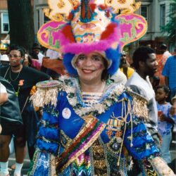 Smiling person in elaborate colorful carnival costume