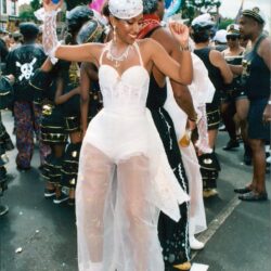 Woman dancing in white costume at carnival