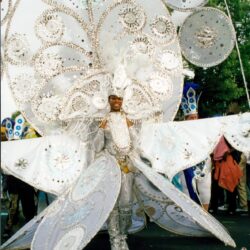 Elaborate white carnival costume with giant circular headdress