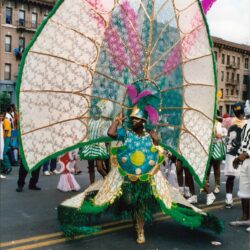Carnival dancer with oversized green and pink costume