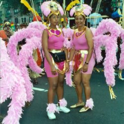 Two women in pink feathered carnival costumes