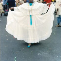 Woman in white traditional dress at parade