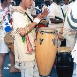 Drummer playing conga drums at street parade