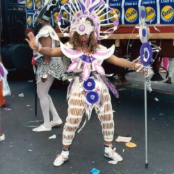 Person in purple and white carnival costume