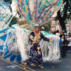 Dancer in elaborate colorful feathered carnival costume