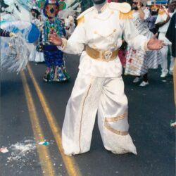 Person in white carnival costume dancing in parade