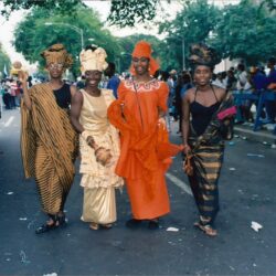 Four women in colorful African attire at parade