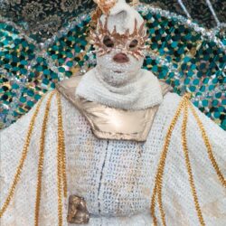 Elaborate white and gold masquerade costume