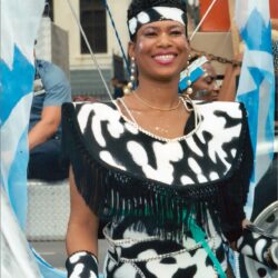 Smiling carnival performer in black-and-white costume