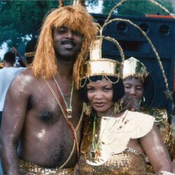 Two people in gold carnival costumes