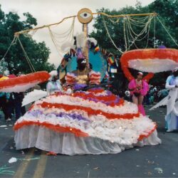 Elaborate carnival costume with oversized parasols