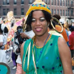 Smiling woman in green carnival costume