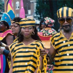 Carnival couple in yellow and black striped outfits