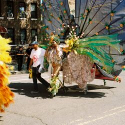 Carnival parade performer in elaborate green costume