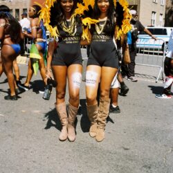 Two women in yellow feathered carnival costumes