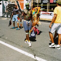 People marching in colorful carnival costumes