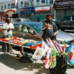 Street vendors selling colorful flags and apparel
