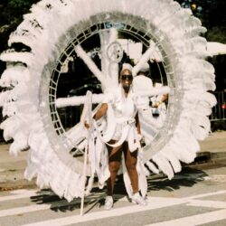 Carnival performer in large white feathered costume
