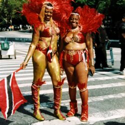 Two women in red feathered carnival costumes