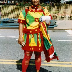 Woman in red, green, yellow flag-inspired outfit