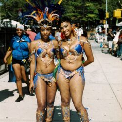 Two women in blue feathered carnival costumes