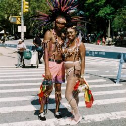 Couple in feathered carnival costumes at parade