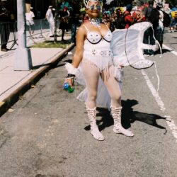 Person in white feathered carnival costume