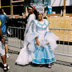 Two women in blue-and-white carnival dresses