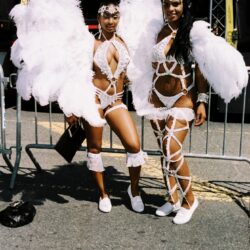 Two women in white feathered carnival costumes